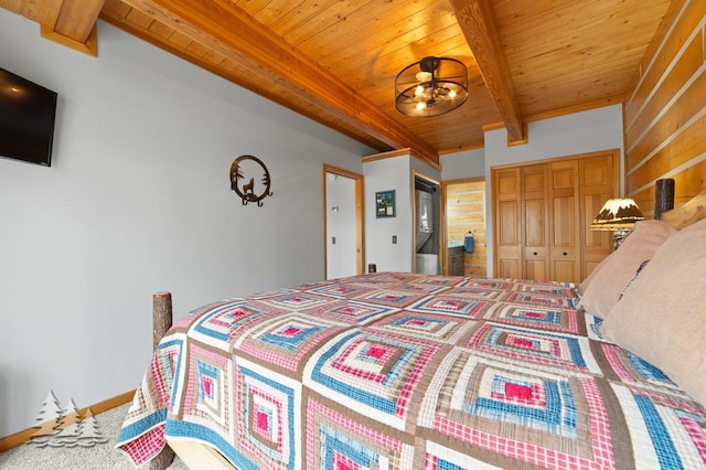 carpeted bedroom featuring wooden ceiling, two closets, and beam ceiling
