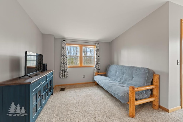 sitting room featuring baseboards, visible vents, and light colored carpet