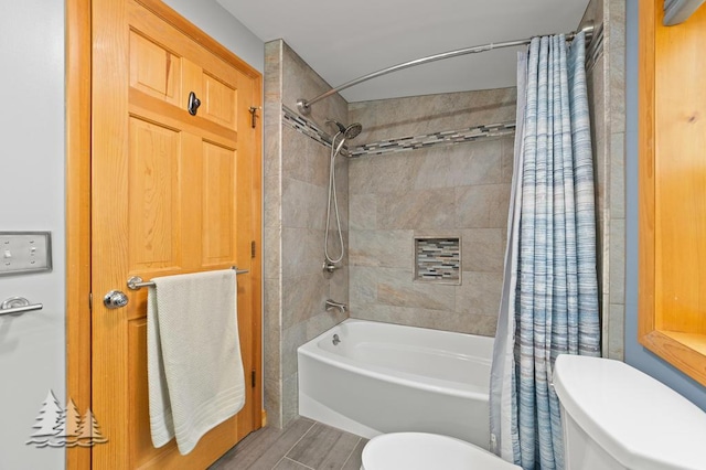 bathroom with toilet, wood finished floors, and shower / tub combo with curtain