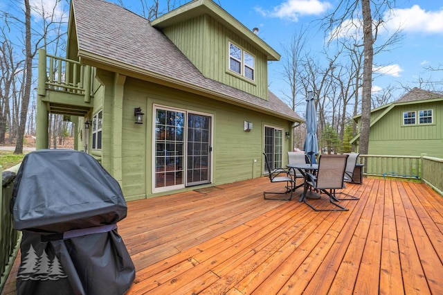 wooden deck featuring outdoor dining area