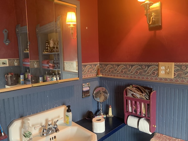 interior space featuring a sink and a wainscoted wall