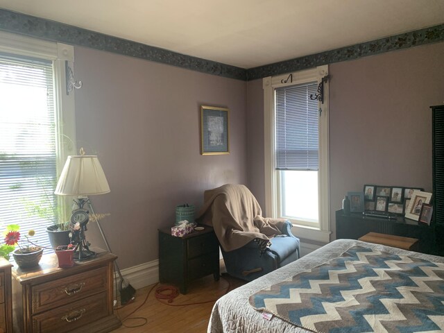 bedroom featuring baseboards and wood finished floors