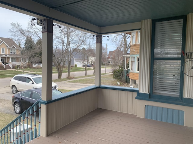 unfurnished sunroom featuring radiator and a residential view