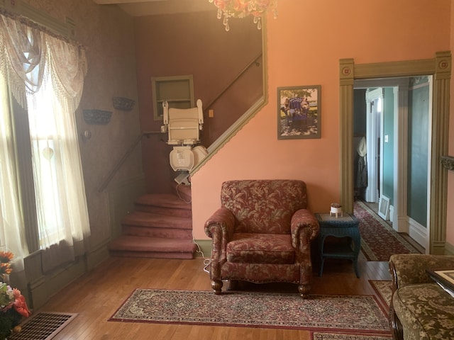 living area featuring stairs, baseboards, and wood finished floors