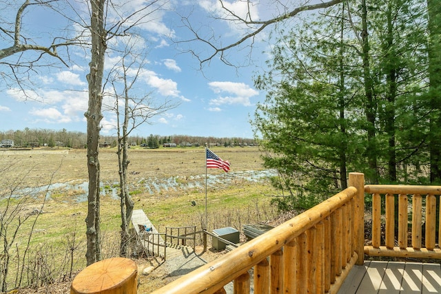 wooden terrace featuring a rural view