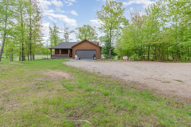 3525 E Pointe Dr, Beaverton, MI 48612 - view of front of home with log siding, dirt driveway, and a garage