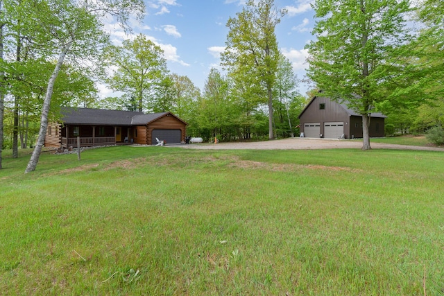 3525 E Pointe Dr, Beaverton, MI 48612 - view of grassy yard with driveway, a garage, and an attached garage