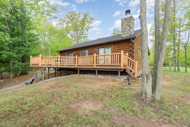 3525 E Pointe Dr, Beaverton, MI 48612 - rear view of house with a wooden deck, log exterior, and a chimney