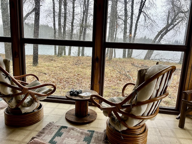 sunroom / solarium featuring a water view and a wealth of natural light