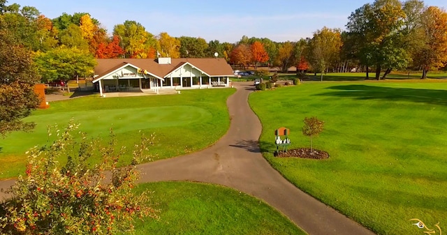1406 Opal Lake Rd, Gaylord, MI 49735 - surrounding community featuring a lawn