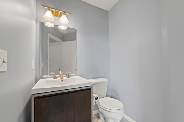 1406 Opal Lake Rd, Gaylord, MI 49735 - bathroom with toilet, vanity, and baseboards