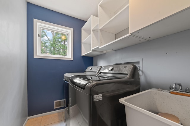 1406 Opal Lake Rd, Gaylord, MI 49735 - laundry area with washing machine and dryer, baseboards, and light tile patterned flooring