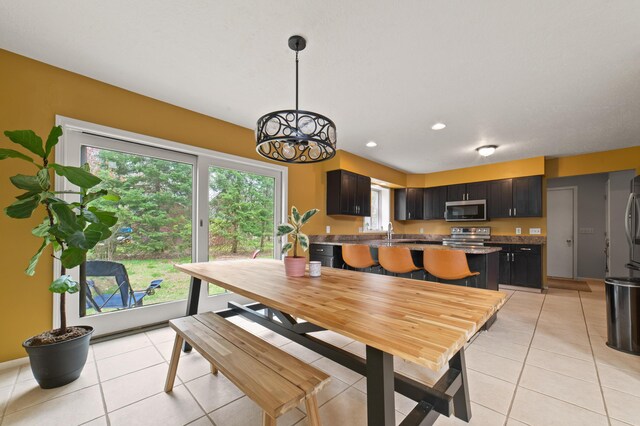 1406 Opal Lake Rd, Gaylord, MI 49735 - dining space with light tile patterned flooring, a chandelier, and recessed lighting