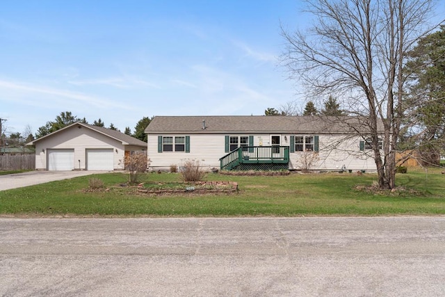 6075 W Edgar St, Pellston, MI 49769 - single story home with a front yard, a wooden deck, and a detached garage
