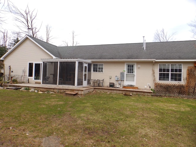 back of house with a lawn, a deck, a sunroom, and a shingled roof