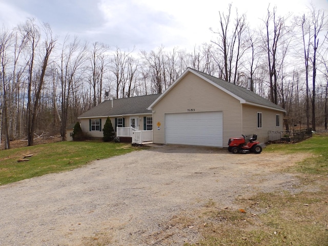 ranch-style home featuring driveway, a garage, and a front yard
