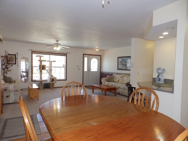 dining area with a ceiling fan and carpet floors
