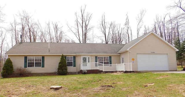 ranch-style house with an attached garage, a front lawn, and driveway