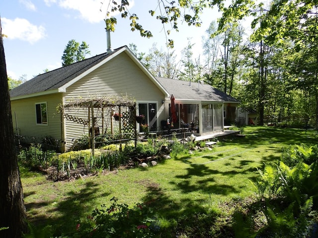 7153 Sugar Hill Cir, Gaylord, MI 49735 - back of house featuring a sunroom, a yard, and a shingled roof