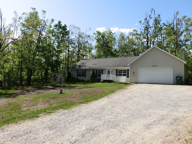 7153 Sugar Hill Cir, Gaylord, MI 49735 - ranch-style home with driveway, a garage, and covered porch