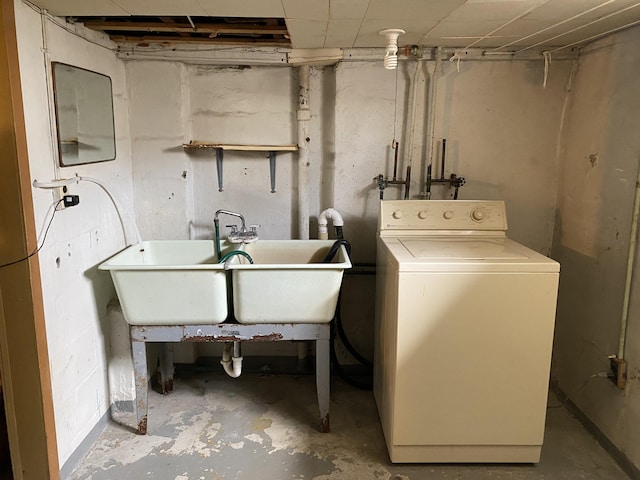 washroom featuring laundry area, a sink, and washer / clothes dryer