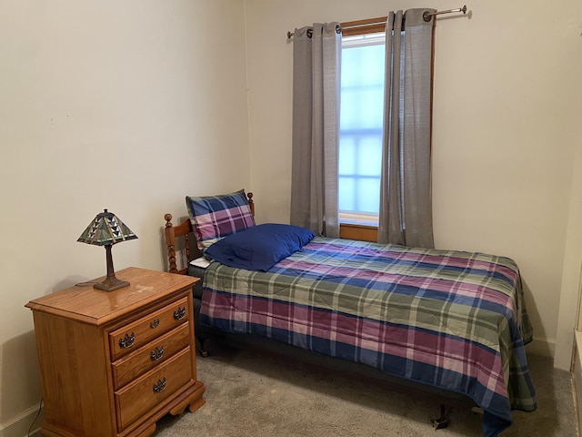 carpeted bedroom featuring baseboards