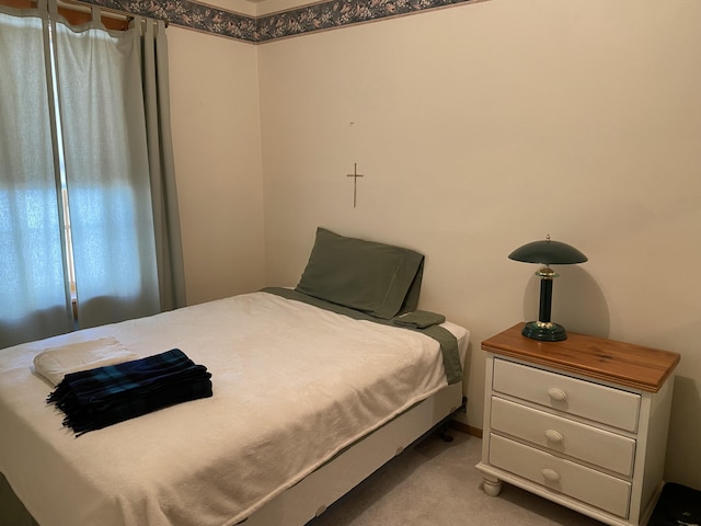 bedroom featuring light carpet