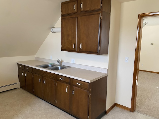 kitchen featuring a sink, light countertops, baseboard heating, and dark brown cabinets