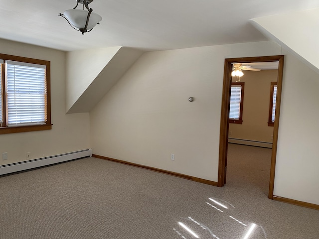 additional living space featuring baseboards, a baseboard radiator, and carpet flooring