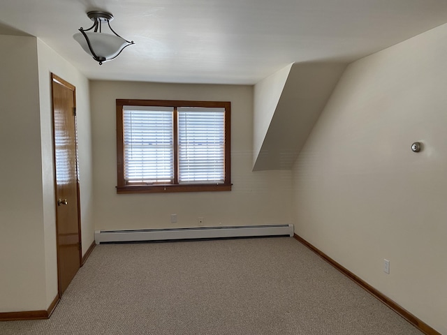 additional living space with baseboards, a baseboard radiator, and carpet flooring