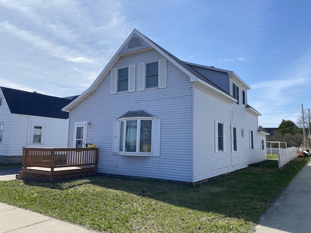 view of front of property with a front lawn and a wooden deck