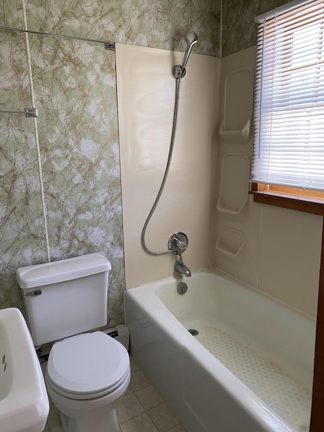 bathroom featuring tile patterned flooring, toilet, wallpapered walls, and bathtub / shower combination