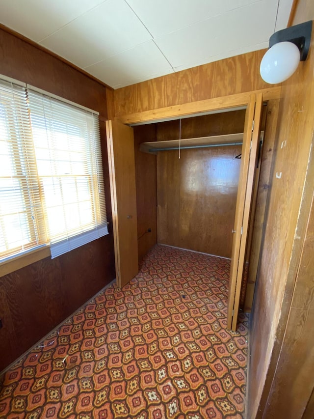 hall featuring wooden walls