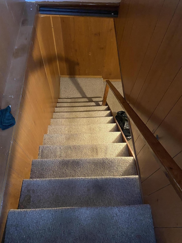 stairs featuring wooden walls