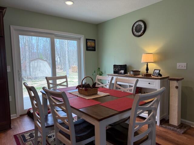 dining area featuring baseboards and light wood finished floors