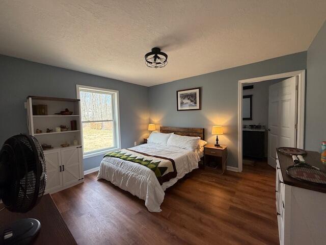 bedroom featuring baseboards and wood finished floors