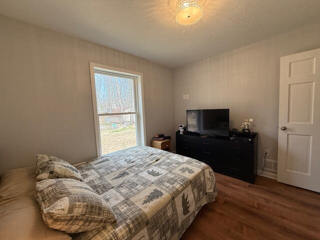 bedroom featuring wood finished floors