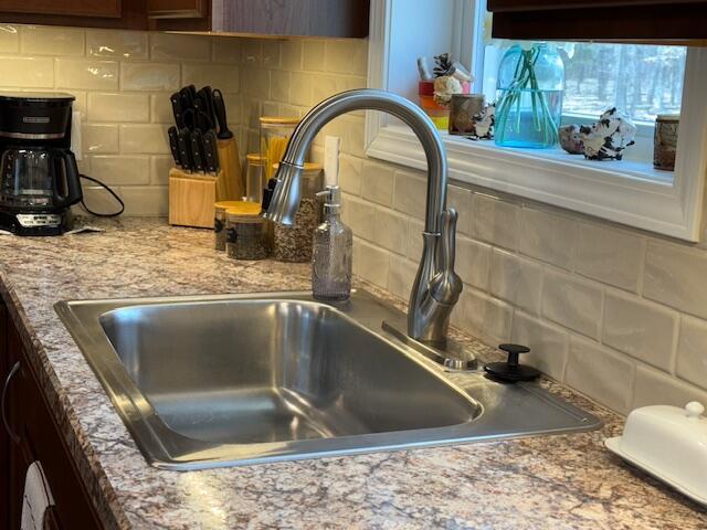 interior details with a sink and tasteful backsplash