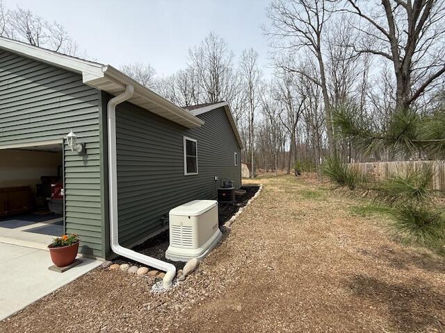 view of side of property featuring a garage and concrete driveway
