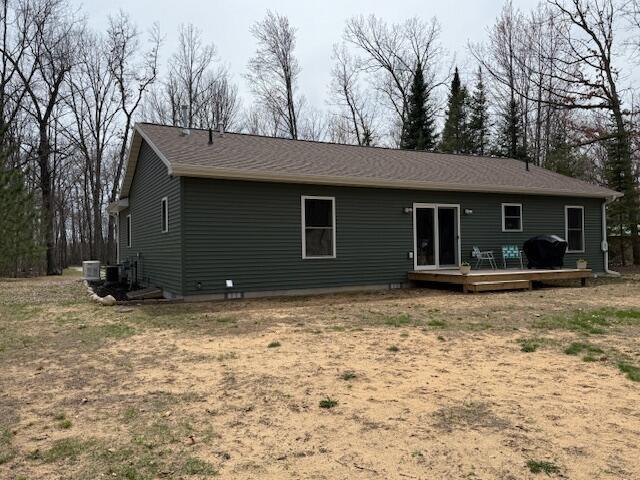 rear view of house featuring cooling unit and a deck