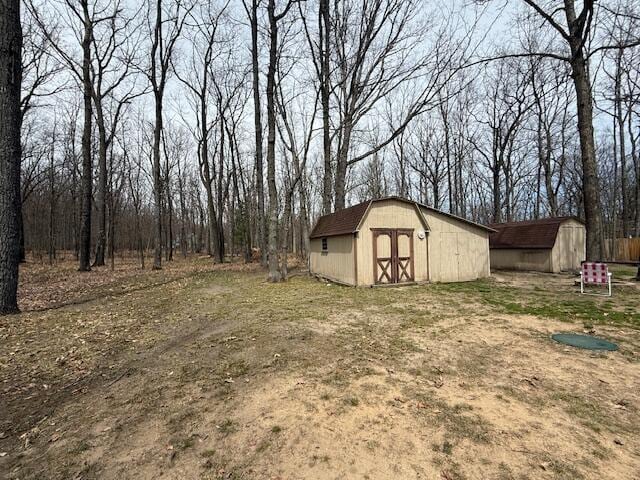 view of yard with a storage shed and an outbuilding
