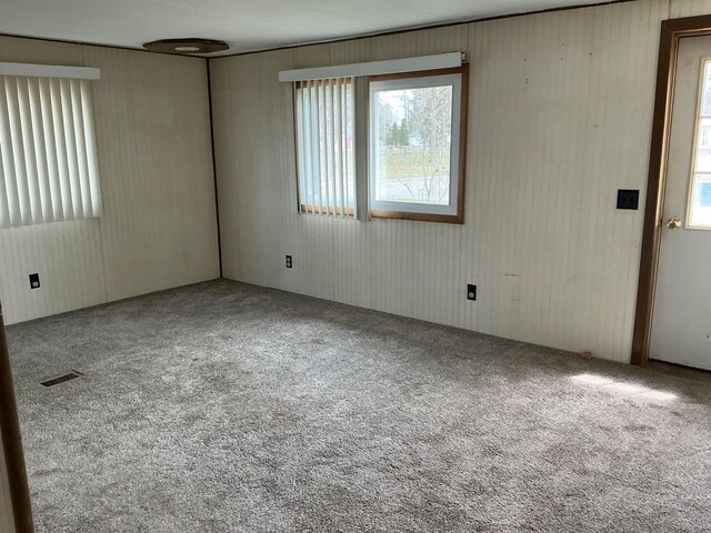 120 Marina St, Houghton Lake, MI 48629 - carpeted empty room with visible vents