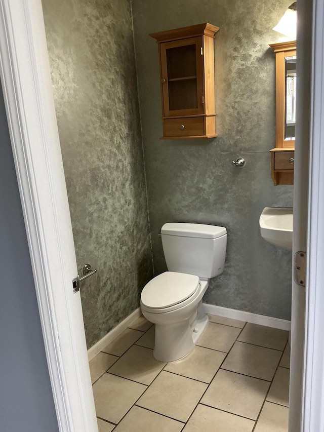 120 Marina St, Houghton Lake, MI 48629 - half bath with toilet, a sink, and tile patterned flooring