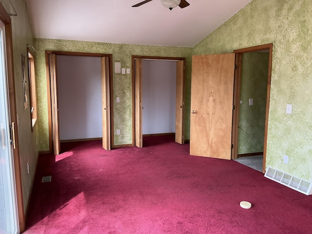 120 Marina St, Houghton Lake, MI 48629 - unfurnished bedroom with vaulted ceiling, two closets, carpet flooring, and visible vents