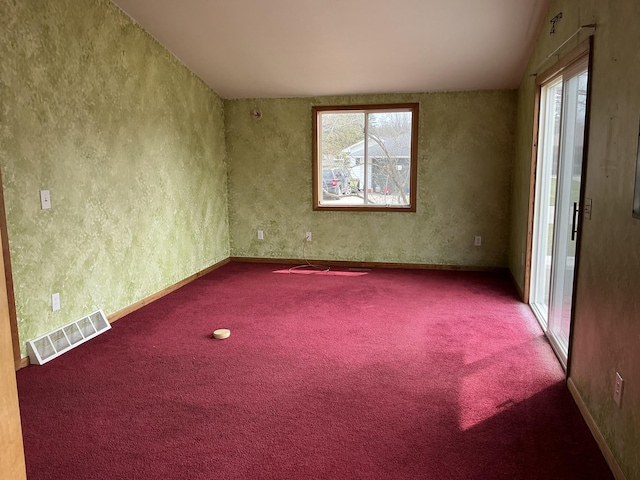 120 Marina St, Houghton Lake, MI 48629 - carpeted spare room featuring visible vents, lofted ceiling, and a wealth of natural light
