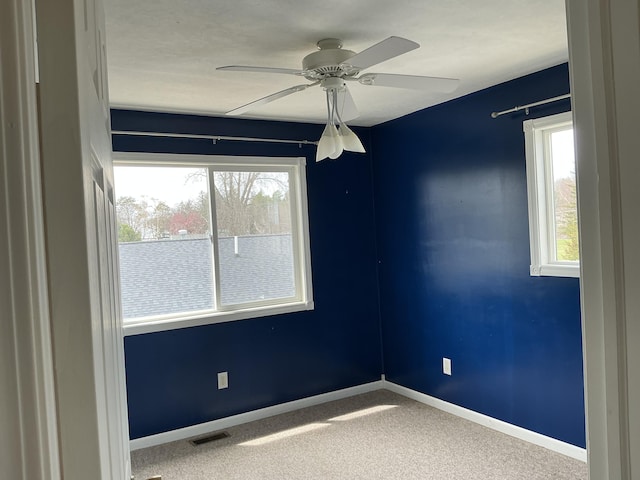 120 Marina St, Houghton Lake, MI 48629 - empty room featuring carpet floors, ceiling fan, visible vents, and baseboards