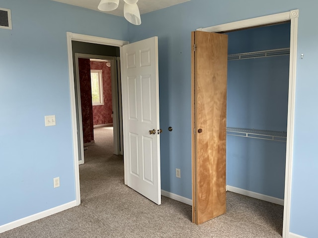 120 Marina St, Houghton Lake, MI 48629 - unfurnished bedroom with carpet floors, baseboards, visible vents, and a closet