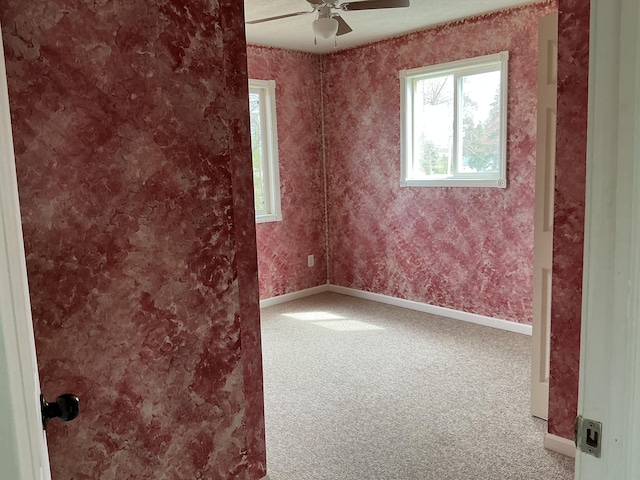 120 Marina St, Houghton Lake, MI 48629 - spare room with baseboards, carpet flooring, and ceiling fan