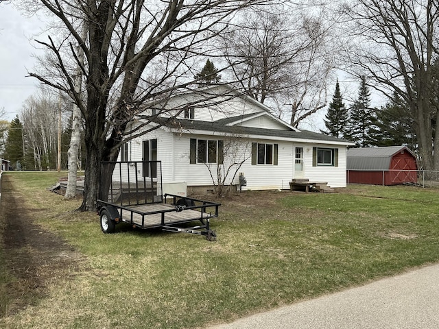 120 Marina St, Houghton Lake, MI 48629 - rear view of property with a yard, crawl space, a storage shed, and an outdoor structure