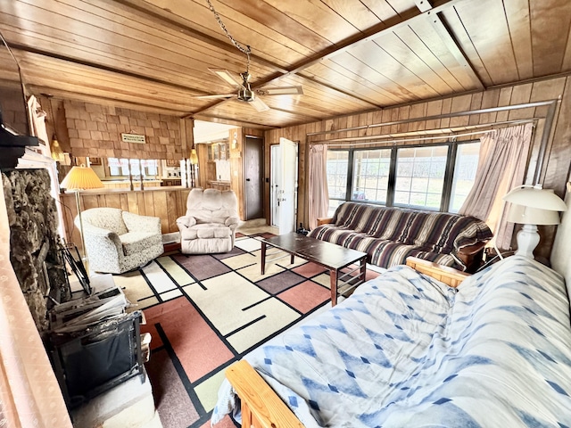 427 Goline Rd, Grayling, MI 49738 - living area featuring a ceiling fan, wooden walls, and wooden ceiling